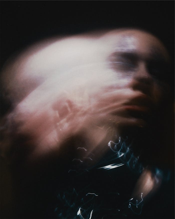 Artistic blurred portrait capturing dynamic motion, creating a surreal effect.